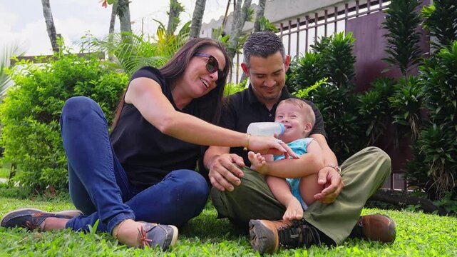 Video of mother caressing her son's foot with Down syndrome while he takes a pacifier
