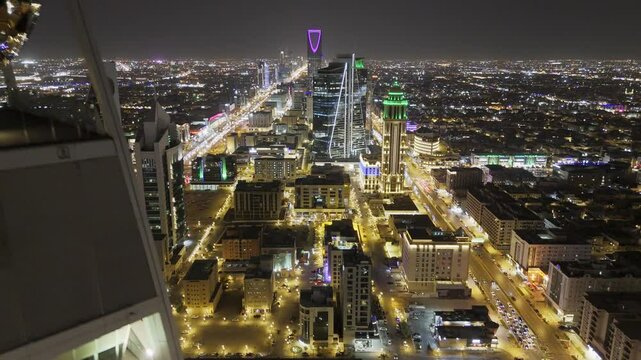 Al Faisaliah Tower pyramid-shaped commercial skyscraper. Riyadh. Drone shot flying. Sunset. Evening.