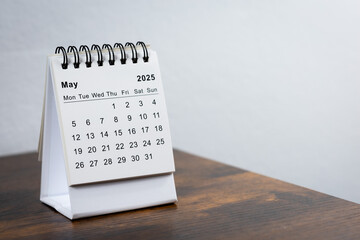 May 2025 calendar on the wooden table. Month page