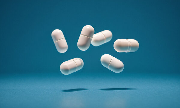 6 six tablets as pills as medicine, healing and symptom suppression, pharmaceutical and prescription drugs, white tablets on blue background floating or falling