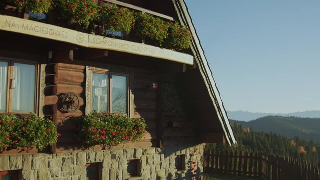 Mountain hut at Maciejowa Mountain in Poland. Autumn, golden hour near sunset. Gorce Mountains. Tourist shelter.