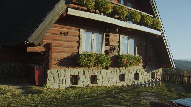 Mountain hut at Maciejowa Mountain in Poland. Autumn, golden hour near sunset. Gorce Mountains. Tourist shelter.