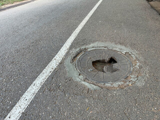 Broken Cast-iron access cover. Manhole cover with damage was repaired several times before the...