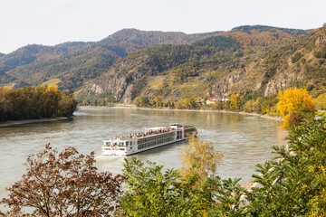 River cruise ship at the river Danube in the Wachau wine-growing area in Austria during autumn