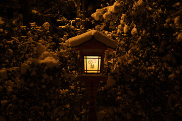 Snow-covered lantern at Yasaka shrine in Kyoto, Japan.