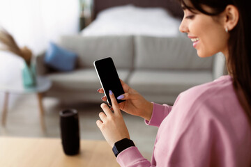 People And Technology Concept. Over The Shoulder View Of Positive Woman Using Smart Phone With...