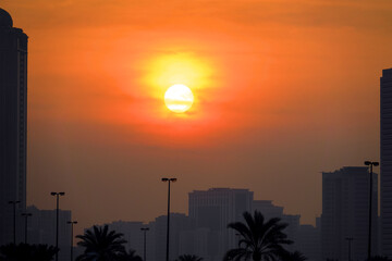 The setting sun in the plumes of a sandstorm. Haboob (simoom) In Dubai