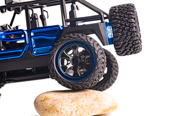 embossed tread of the SUV wheels is isolated on a white background.. Toy, close-up.