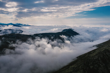Obraz premium Dense fog and low cloudy sky on the high peak in the early morning. Serene mountain landscape with layered fog under the sky.Rize, Kackar Mountains.