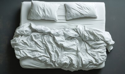 Obraz premium Top view of an unmade bed with white sheets and pillows, showing wrinkled and messy bedding. --ar 5:3 --v 6.1 Job ID: bff803dd-f713-4c6b-b357-de0d894a7a8e