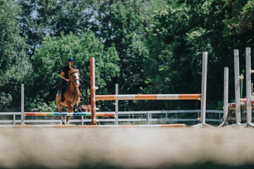 Rider on a horse engaging in competitive equestrian jumping event in an outdoor environment with...