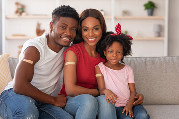 Coronavirus Vaccination. Vaccinated Black Family Of Three With Adhesive Bandage On Arms Posing At...