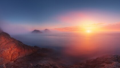 Naklejka premium A fantastic winter mountain scene in thick fog, with the beautiful light of the sunset illuminating the peaks, creating a mystical and serene atmosphere as the sun dips behind the snowy mountains.