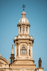 Fototapeta premium The north tower bell of the Metropolitan Cathedral of Santiago, Chile, adorned with intricate details. Ignacio Cremonesi designed the two towers in a neoclassical style with baroque elements.