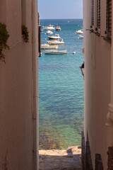 View of boats through a narrow street, Cadaques, Spain