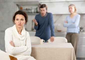 Man and mature mother yell at adult sister. Family conflict between relatives kinfolk