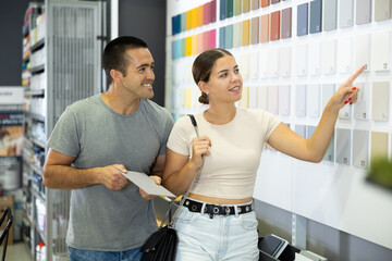Married couple chooses ceramic tiles for kitchen or bath at a hardware store