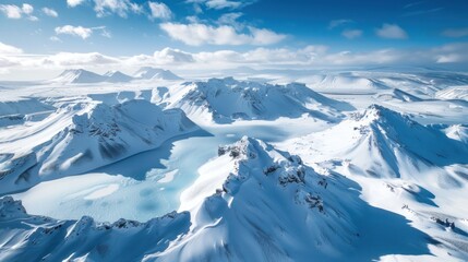 Obraz premium Aerial view of snow-covered mountains and a glacial lake.