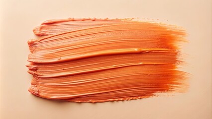 Abstract orange cosmetic smear on a neutral background, showcasing texture and color for beauty product promotion