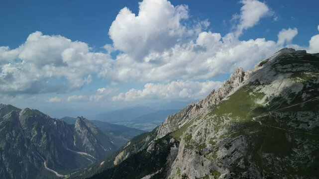 Aerial footage of the scenic Kamnik Savinja Alps mountain range on a sunny day in northern Slovenia