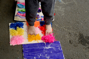 Infant sensory stimulation therapy: child stepping on sodium polymer (sodium polyacrylate), a...