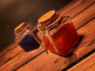 Health and mana potions on a wooden table, as decoration for a medieval fantasy atmosphere