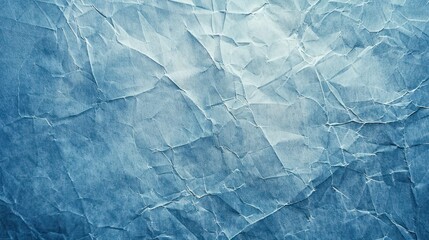 Obraz premium A textured background featuring crumpled blue paper, ideal for design and artistic projects.