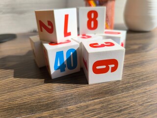 Cubes with numbers on a wooden table
