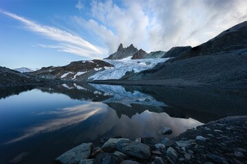Summer landscape view of a glacier and mountain range reflecting in a lake