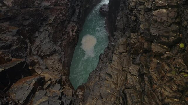Immersive aerial shot of Hell&rsquo;s Hole, dynamically moving through the cliff inlet