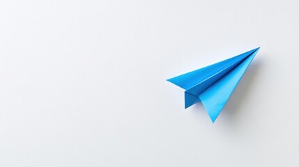 A single blue paper airplane sits on a white background, pointing to the right.