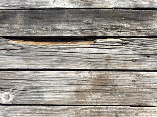 A wooden surface with a grainy texture and a few holes