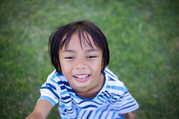 A sad little girl sitting alone outside
