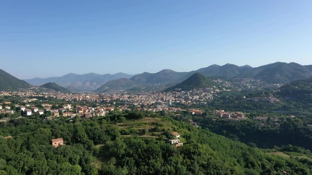 Aerial view from high altitude of rocky mountains and houses on hills near Vietri Sul Mare on a sunny summer day, Raite, Salerno, Italy