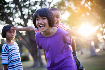 group of cute asian kids having fun in the park