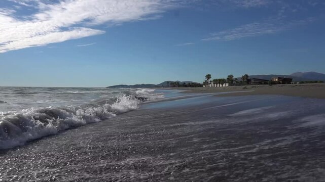 Silver waves of the sea on the sandy beach