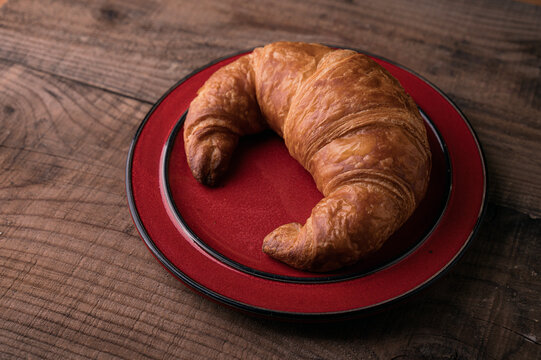 Freshly Baked Croasant on red Plate