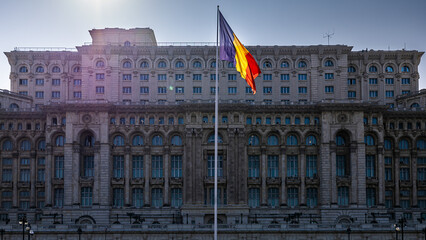 Palace of the Parliament and the national flag of Romania. Concept photo for the parliament and...