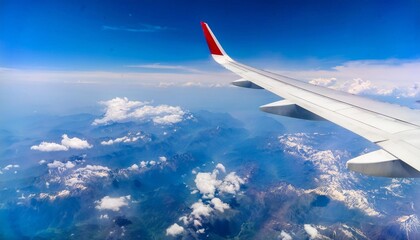 Obraz premium View from the airplane window, wing and sunrise in background