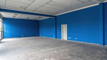 A bold blue wall makes a statement in the empty room, minimalist decor, contemporary style, bold accent wall