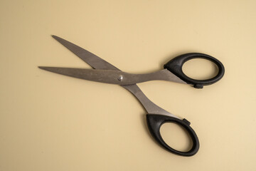 A pair of scissors is laying on a table