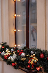 Close-up of festive Christmas decorations and string lights in a window