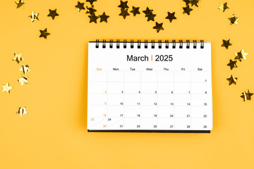 March 2025 calendar and scattered sparkling yellow confetti stars.