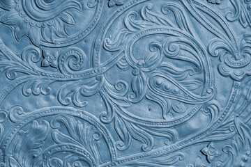 Fragment of an ancient coin with an ornate floral pattern