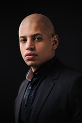 Obraz premium Portrait of adult african american man in formal wear looking at camera isolated on black