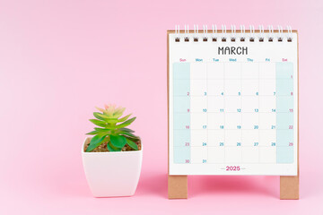 Desk calendar for March 2025 with plant pot.