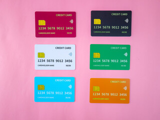 Colorful mock-up of six credit cards in various colors on a pink background