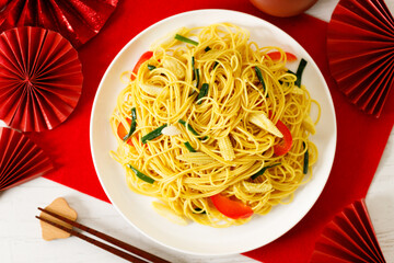 Chinese Lunar New Year concept with lucky food longevity noodles on wooden table background.