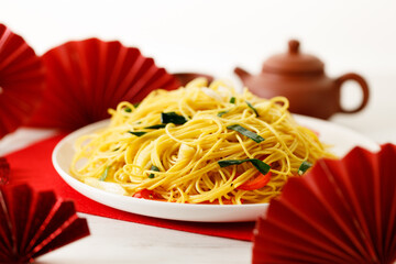 Chinese Lunar New Year concept with lucky food longevity noodles on wooden table background.