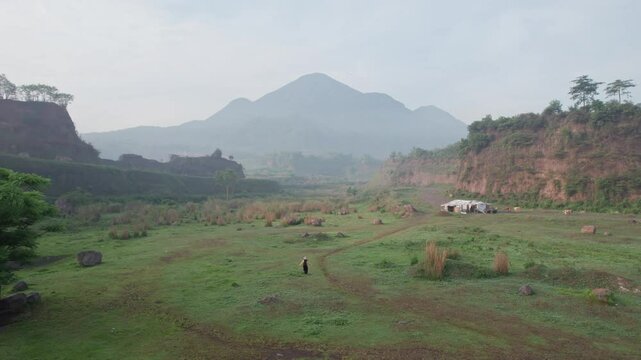 Aerial view of Ranu Manduro in East Java, Indonesia, captured by a professional on January 9, 2024. The video showcases the morning landscape of the savanna with a mountain in the background